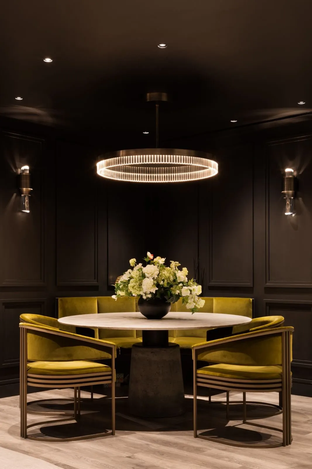The dining corner beneath a halo pendant