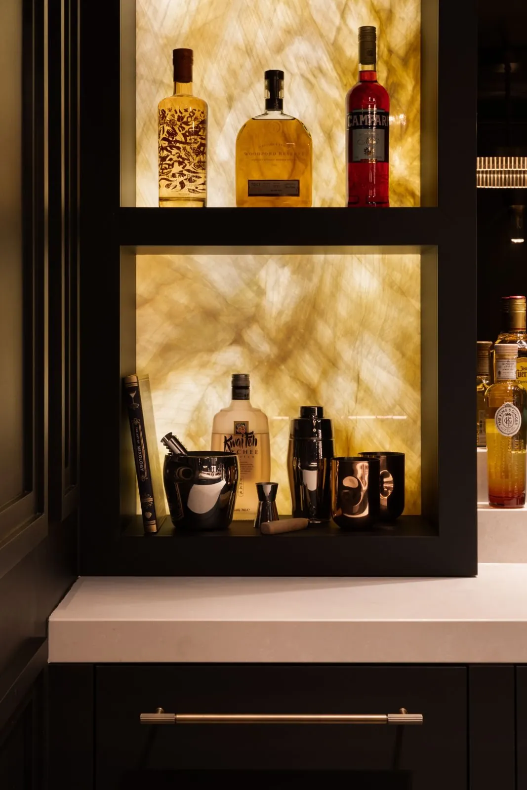 Backlit onyx shelving behind the bar