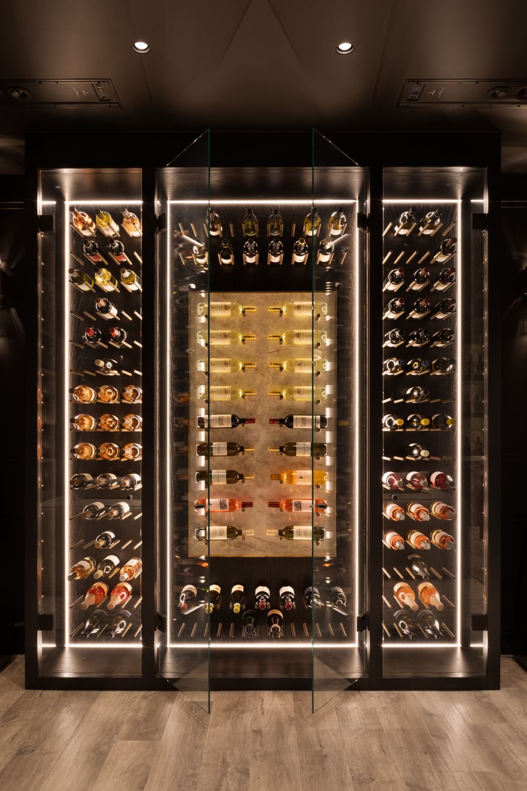 An illuminated glass wine wall